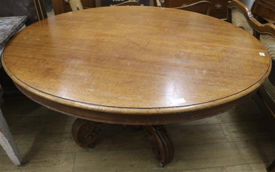 An oak oval extending centre table, W.150cm